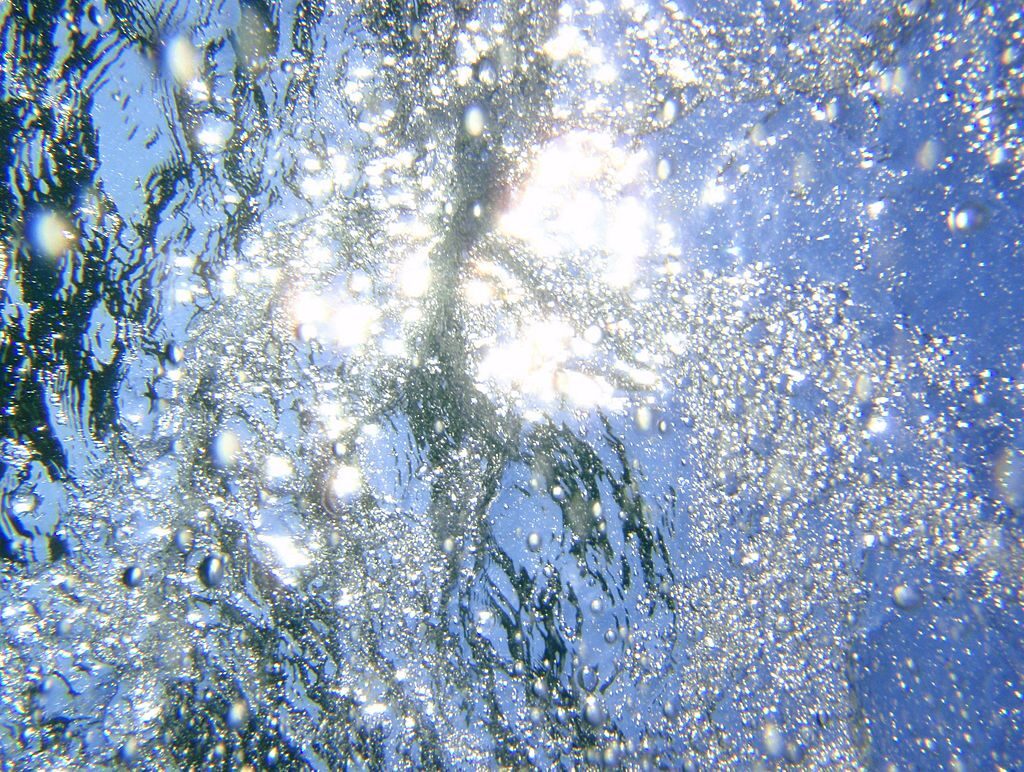 water with bubbles and sunlight shining through