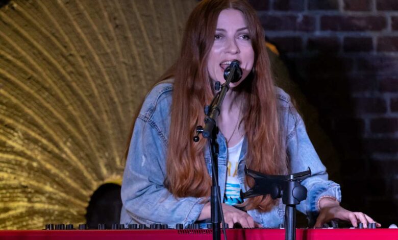 a woman singing into a microphone