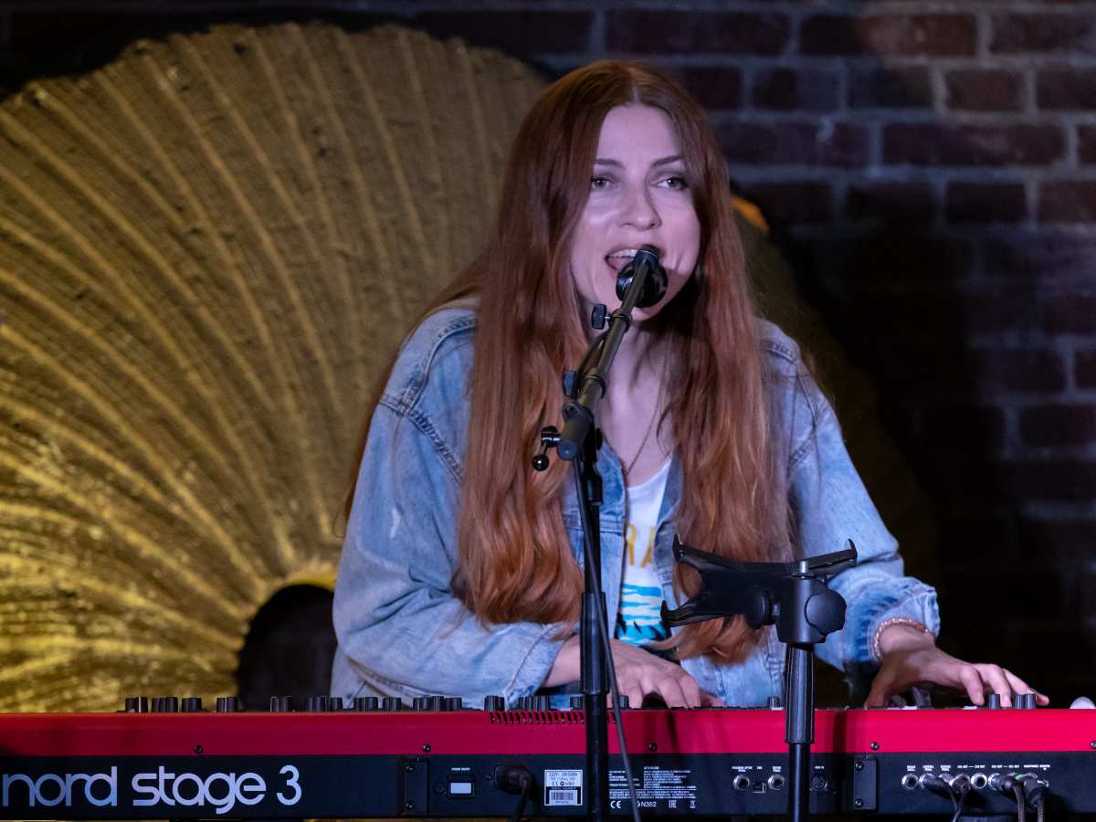 a woman singing into a microphone