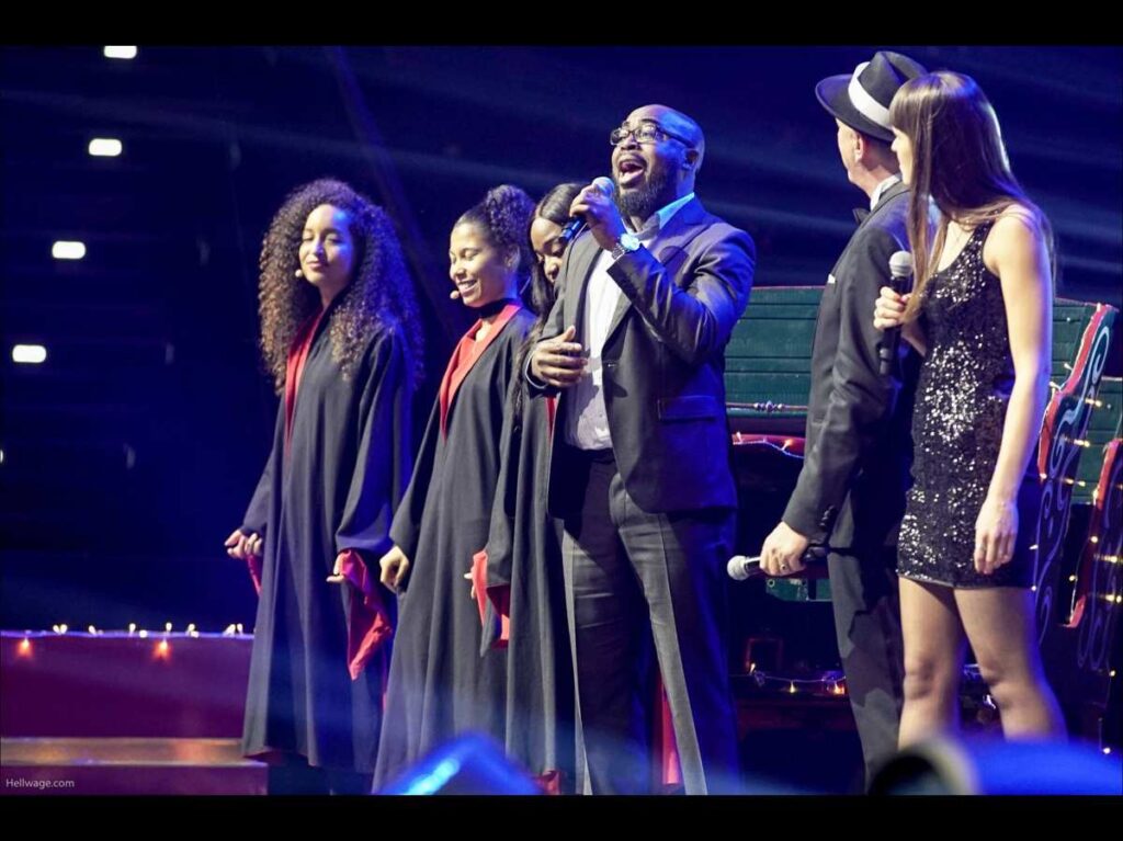 a group of people singing on a stage