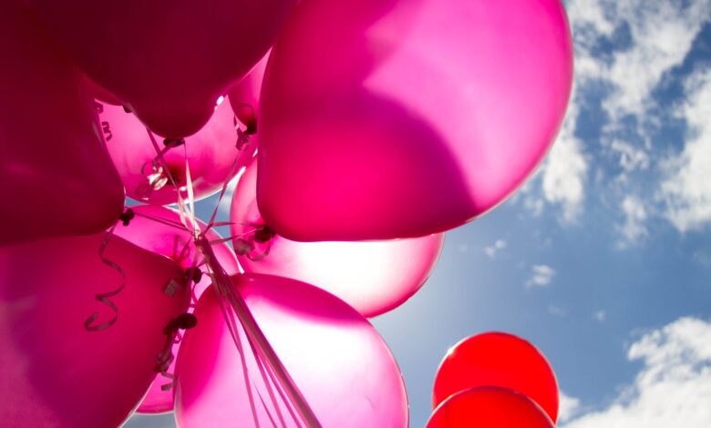 low angle shot of pink and red balloons