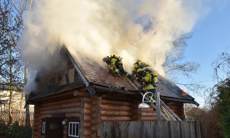 Das Bild zeigt Feuerwehrmänner auf einem brennenden Hausdach