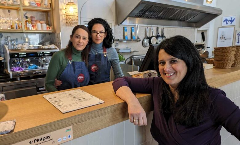 a group of women standing behind a counter