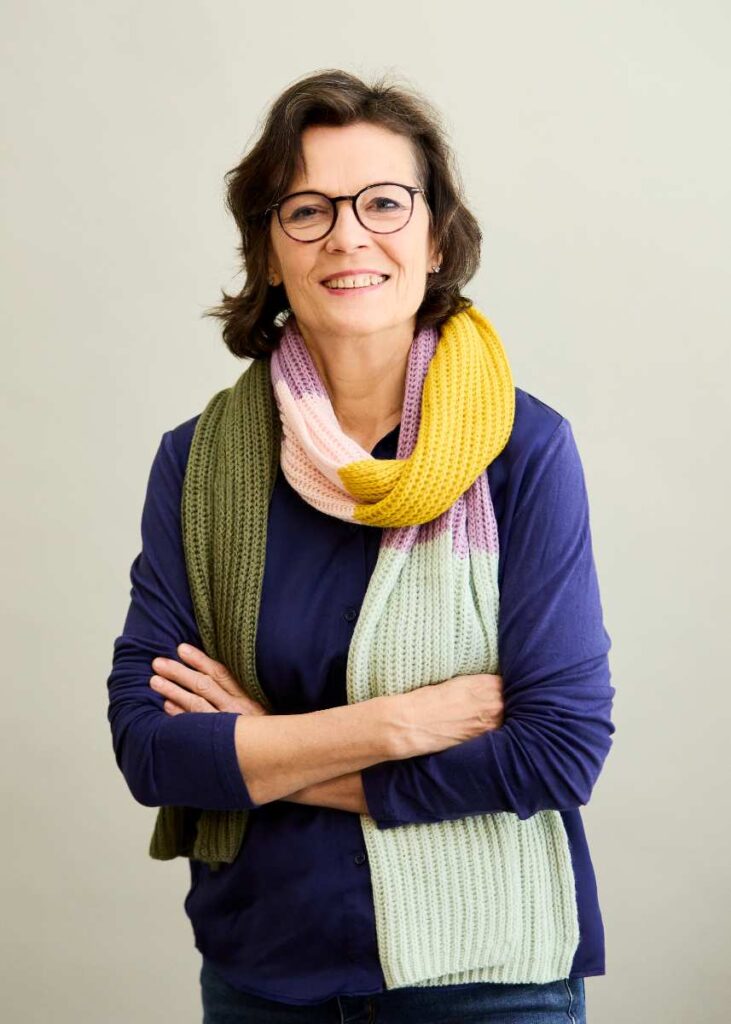 a woman wearing glasses and a scarf