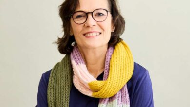 a woman wearing glasses and a scarf