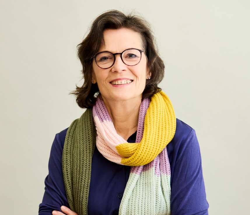 a woman wearing glasses and a scarf