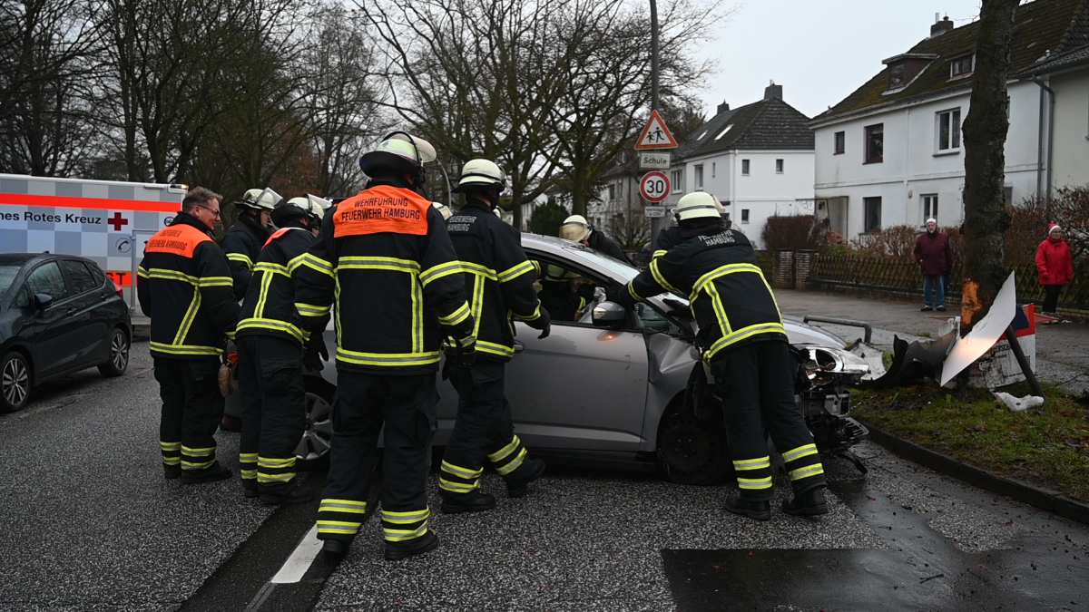 a group of firefighters standing around a car