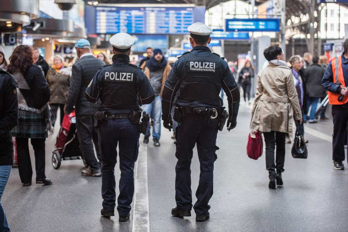 two police officers walking in a train station