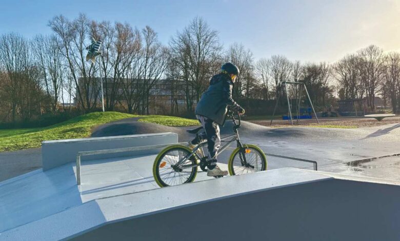 a person riding a bike at a skate park