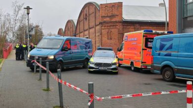 a group of cars parked in front of a brick building