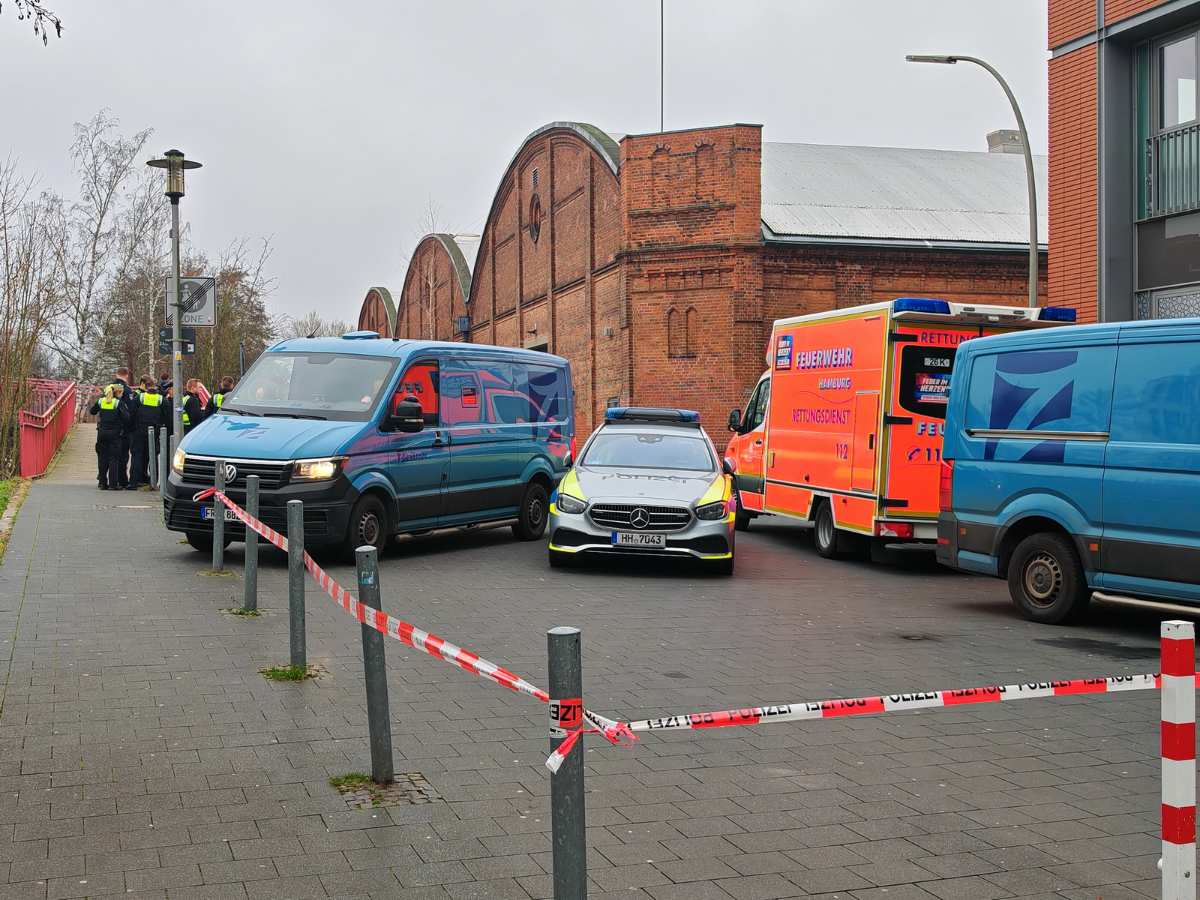 a group of cars parked in front of a brick building