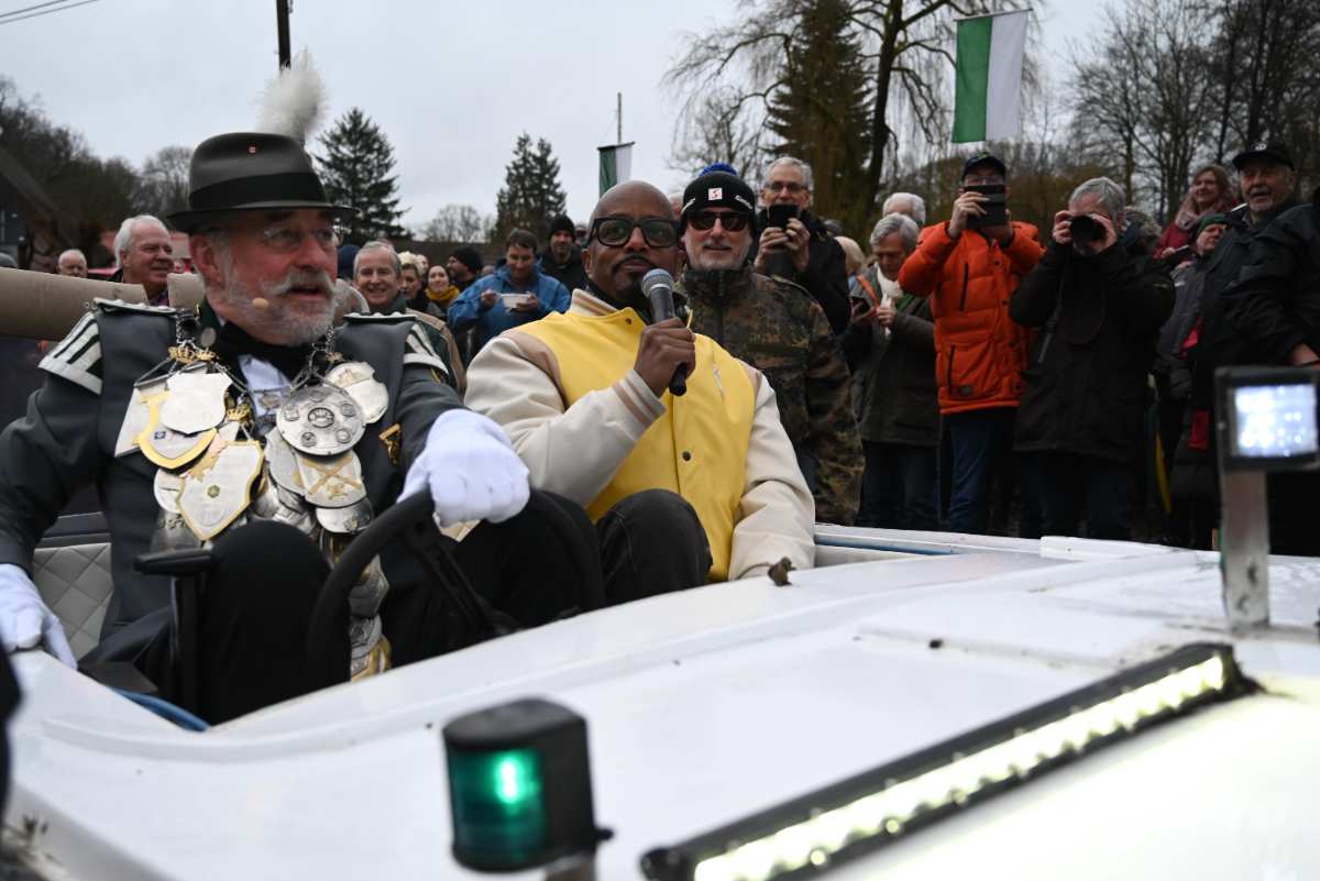 a man in garment speaking into a microphone