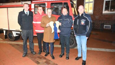 a group of men standing in front of a fire truck