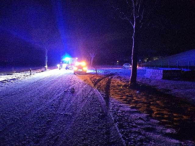 a car on a snowy road at night