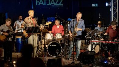 a group of people playing instruments on a stage