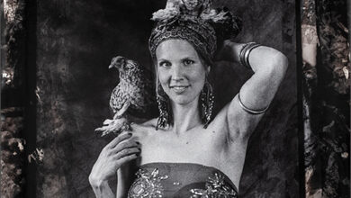 a woman holding two birds on her head