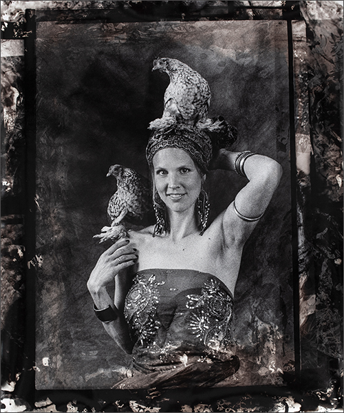 a woman holding two birds on her head