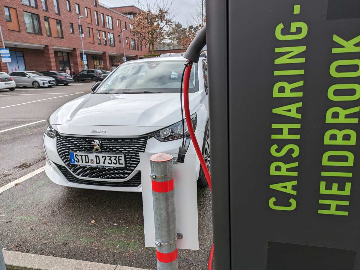 a white car parked next to a power supply