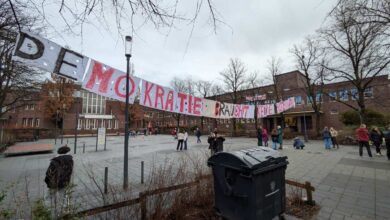 a group of people outside with a sign on the side