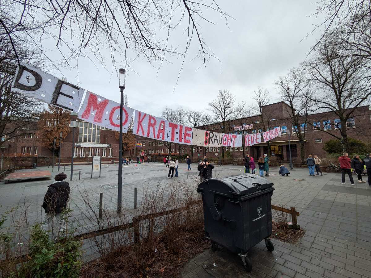 a group of people outside with a sign on the side