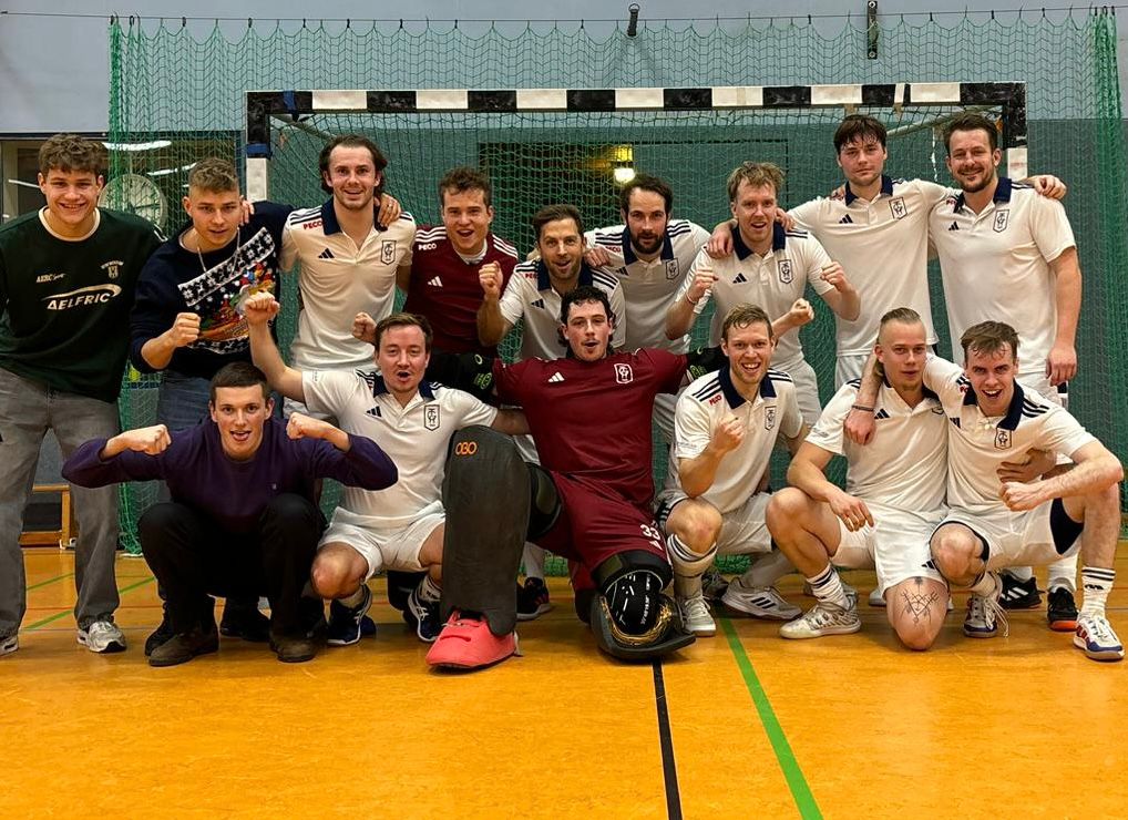 a group of men in sports uniforms posing for a photo