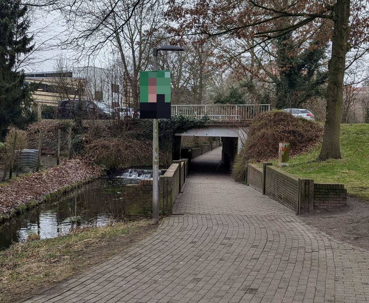 a brick path with a sign on it