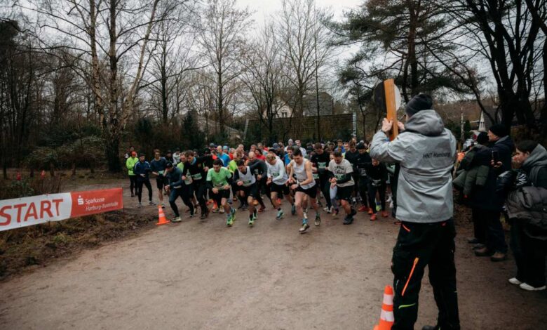 a group of people running on a dirt road