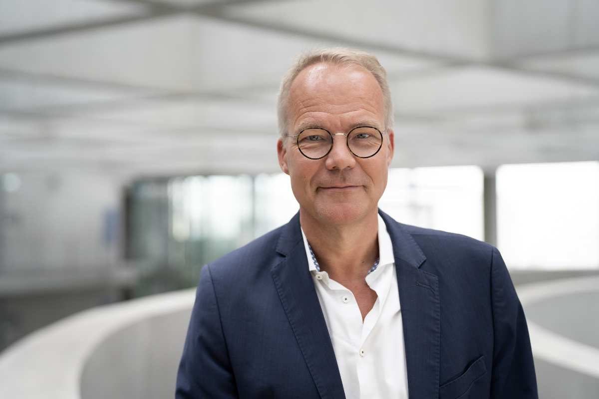 a man wearing glasses and a suit