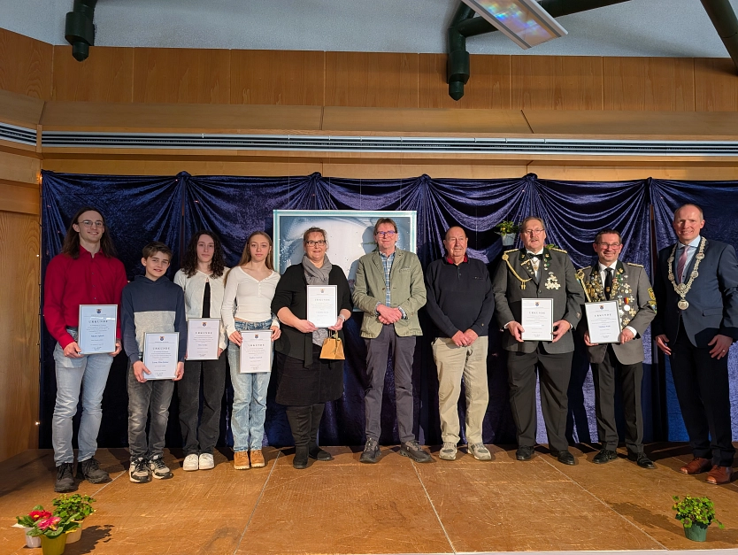 a group of people holding papers