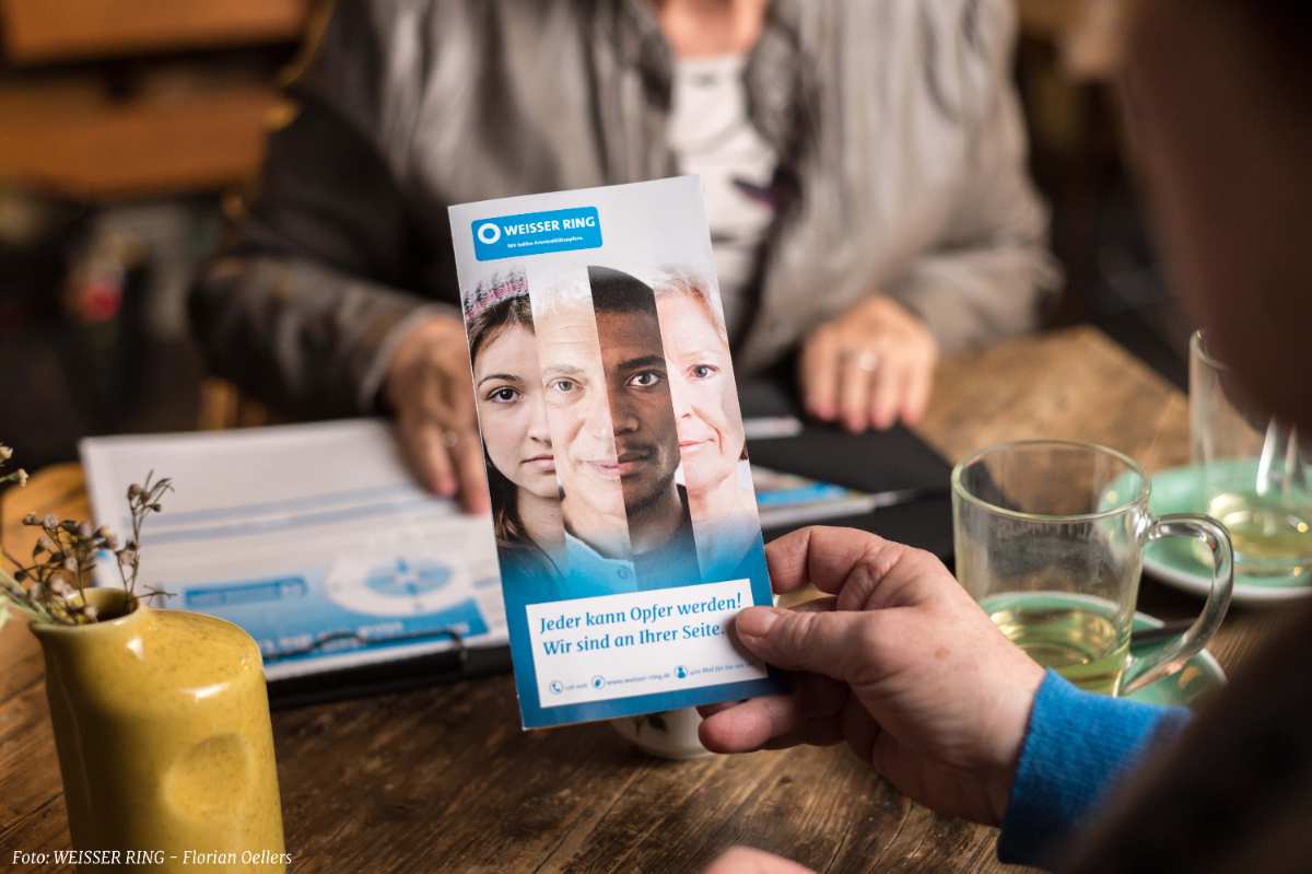 a hand holding a brochure