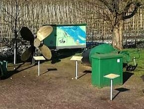 a propeller and trash cans in a park