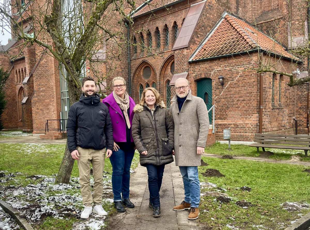 a group of people standing in front of a brick building