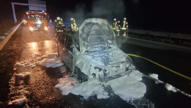 a car with a fire engine on the side of the road