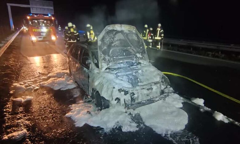 a car with a fire engine on the side of the road
