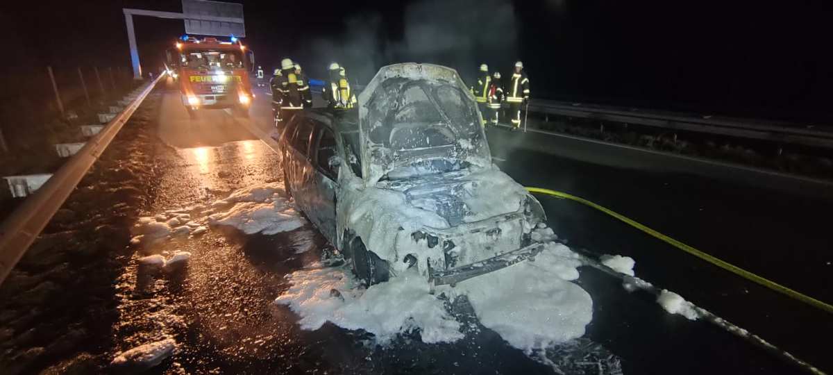 a car with a fire engine on the side of the road