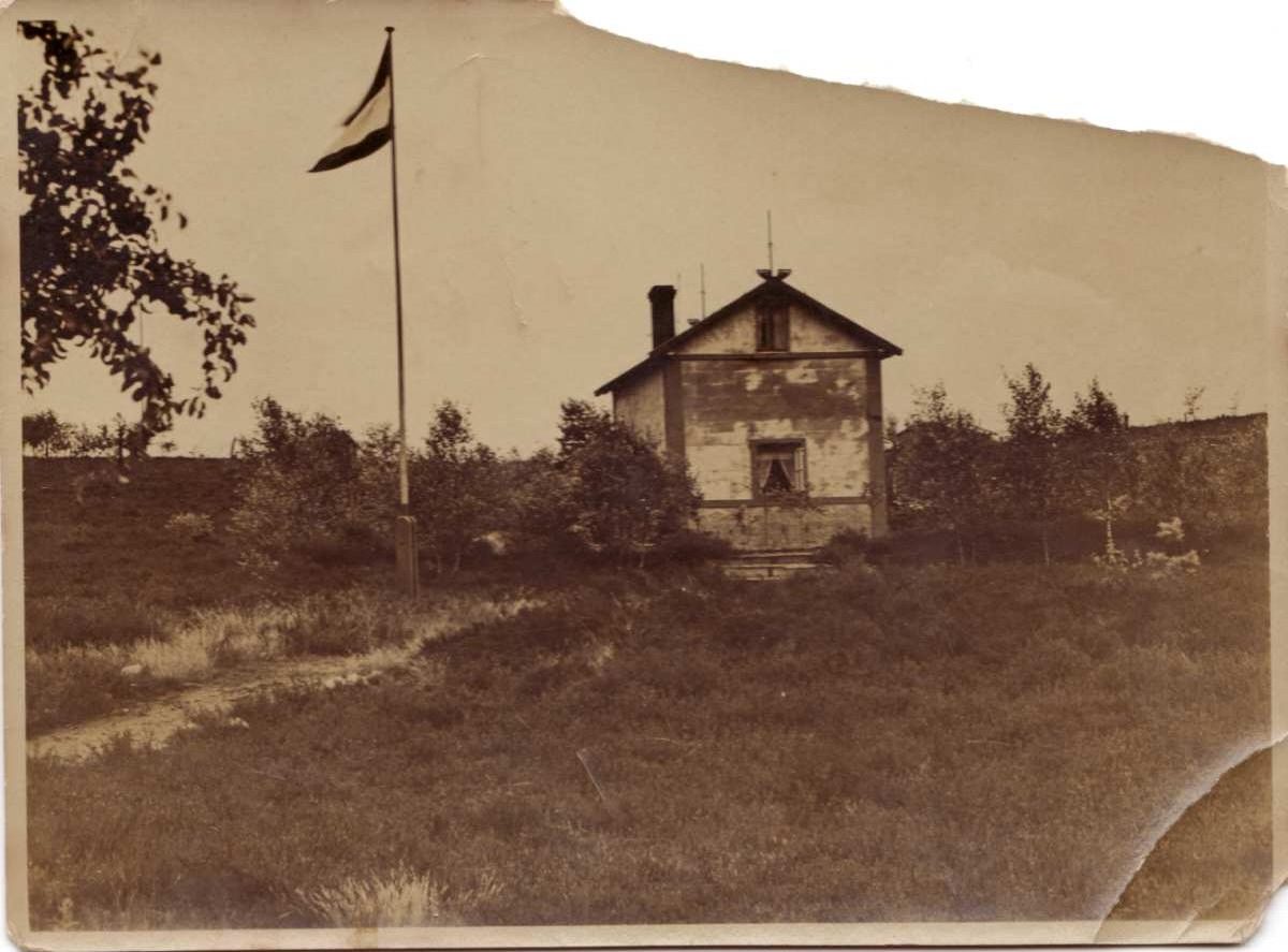 a building with a flag on a pole