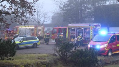 a fire engine and police cars in a yard