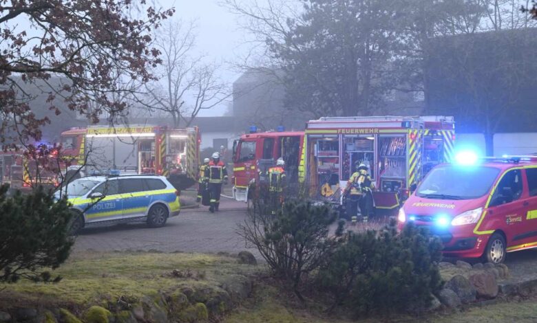 a fire engine and police cars in a yard