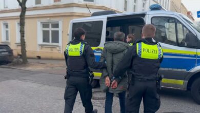 police officers in uniform holding hands to a woman