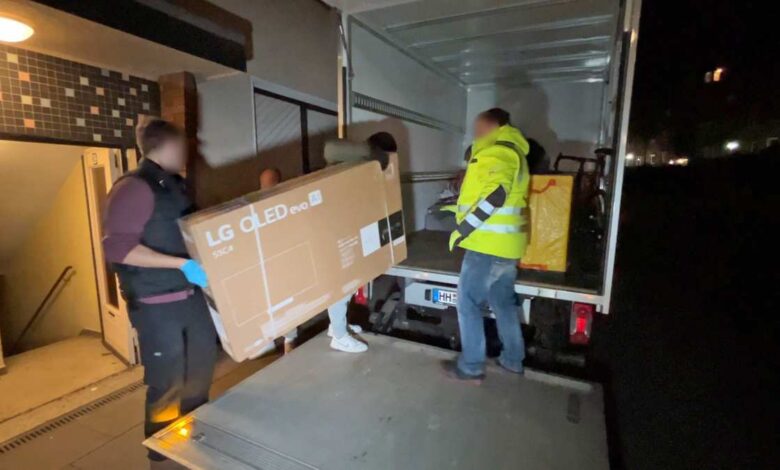 a group of people loading a box into a truck