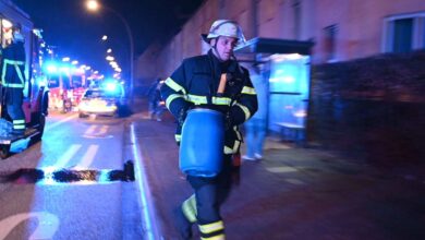 a firefighter carrying a barrel of water