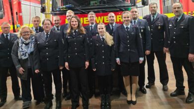 a group of people standing in front of a fire truck