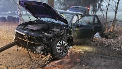 a wrecked car with its hood up