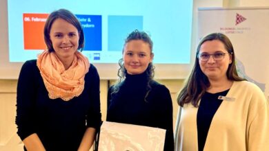 a group of women standing in front of a projector screen