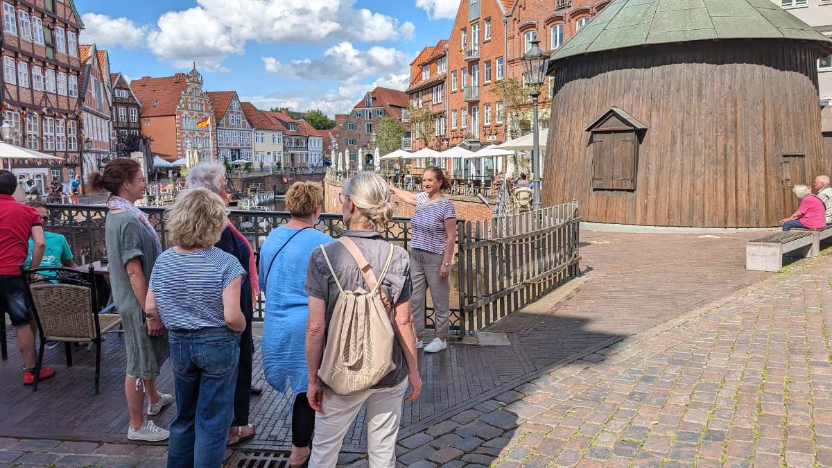 a group of people standing on a brick walkway