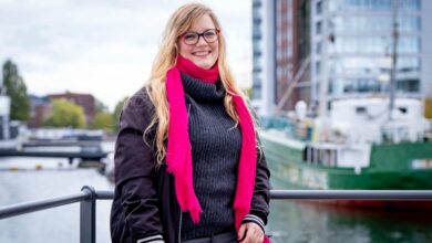 a woman wearing glasses and a pink scarf