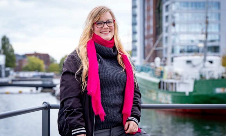 a woman wearing glasses and a pink scarf