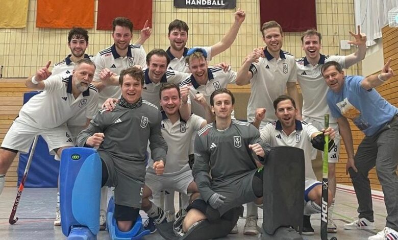 a group of men in sports uniforms posing for a photo