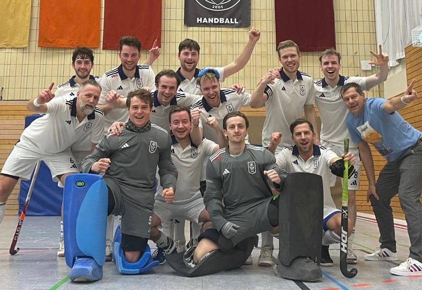 a group of men in sports uniforms posing for a photo