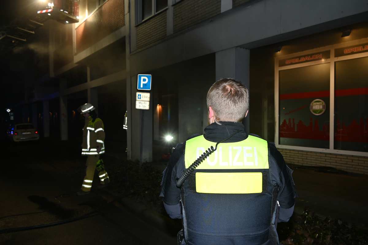 a man in a uniform standing in front of a building